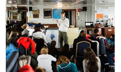 Fern Wickson presenting her research during a “Symposium at Sea” aboard the vessel Ushuaia as part of the Homeward Bound Leadership programme for women in STEMM  PHOTO: Homeward Bound