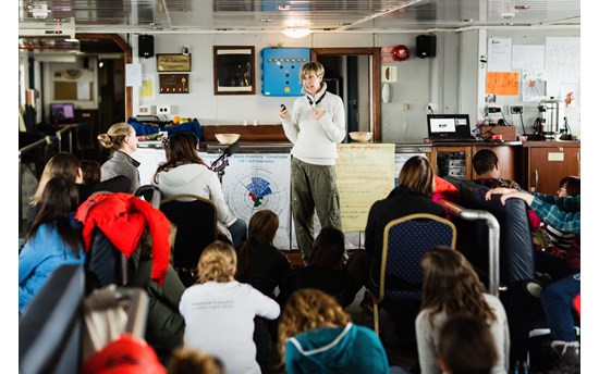 Fern Wickson presenting her research during a “Symposium at Sea” aboard the vessel Ushuaia as part of the Homeward Bound Leadership programme for women in STEMM  PHOTO: Homeward Bound