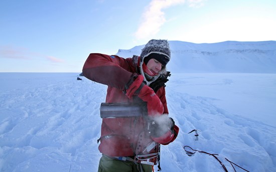 Erlend pouring himself a hot drink in the Arctic