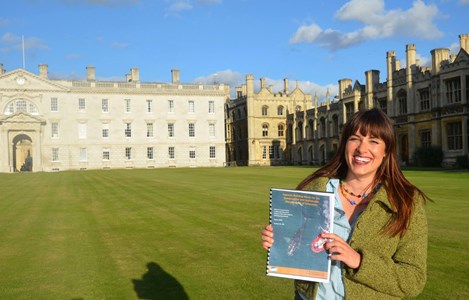 Jodi holding up her completed thesis at the University of Cambridge on Capacity Development of Developing Countries of the International Whaling Commission