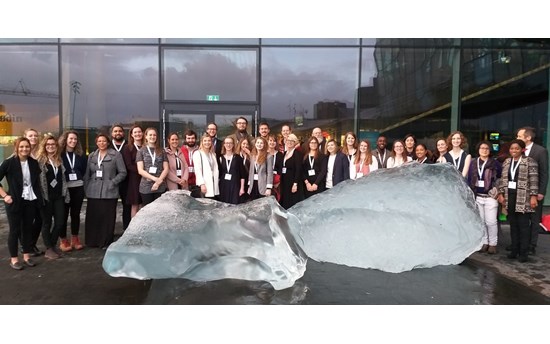 Students, staff and faculty at the Arctic Circle in front of Icebergs from Kommuneqarfik Sermersooq Municipality in Greenland.