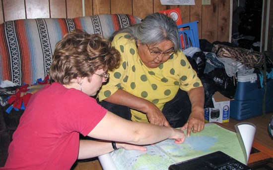 Dr. Olga Lovick (PhD) reviews Upper Tanana place names with the late Cora H. David, an Elder, storyteller and teacher, at David’s home in Tetlin, Alaska, in 2009  PHOTO: Siri G. Tuttle