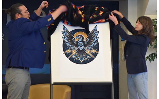 Co-Directors Robin Sutherland, left, and Larissa Speak unveiled the Institute's new logo, a Thunderbird.