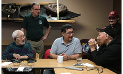 Seated from left are Sikumiut members Gamalie Kilukishak (deceased), Caleb Sangoya and David Angnatsiak (deceased) telling stories about sea ice in Mittimatalik in 2017. Standing from left are Dr. Trevor Bell and Malachi Arreak. Photo from: Memorial University